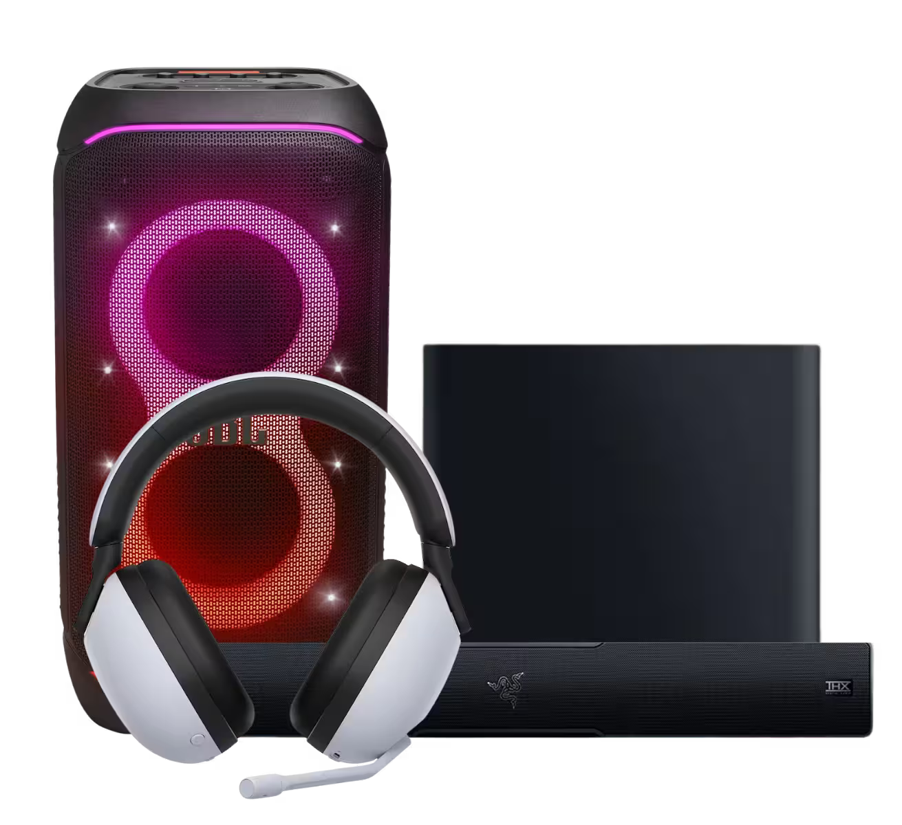 A gaming bundle featuring a black portable speaker with glowing pink and red LED rings, a white and black over-ear headset with a microphone, a black rectangular device, and a black Razer bar with the Razer logo.